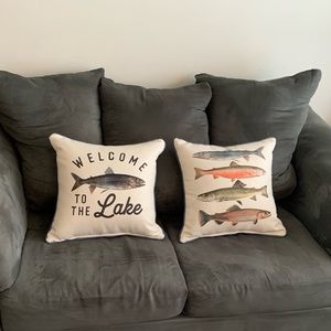 Two throw pillows. New. Never used. Only stored. Cream color with blue cording.